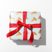 Gift box with pizza pattern and red ribbon on a white background