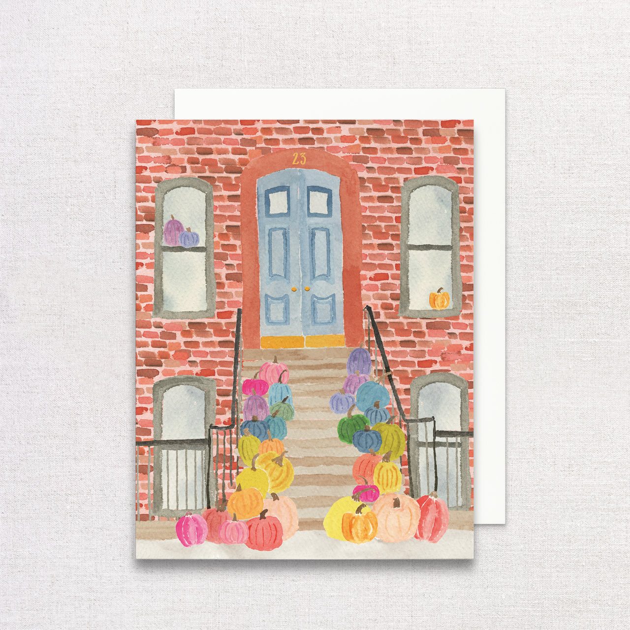 Greeting card with a colorful pumpkins on a city stoop design on a white background