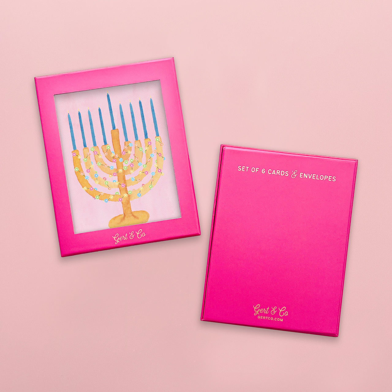 Pink card with Menorah design and pink card holder on a pink background