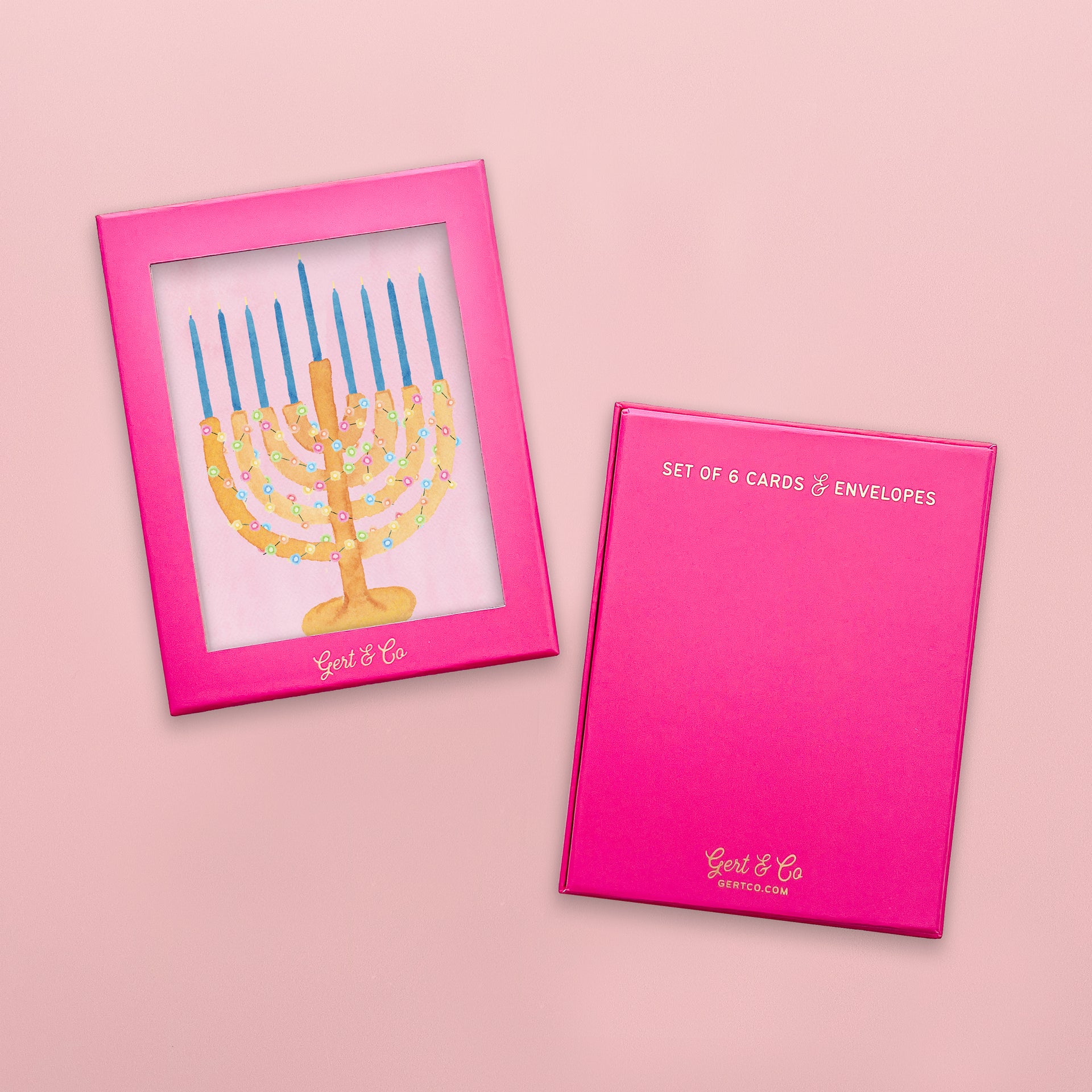 Pink card with Menorah design and pink card holder on a pink background