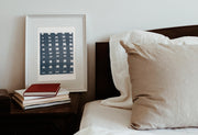 mud cloth art print framed next to a bed by Gert & Co