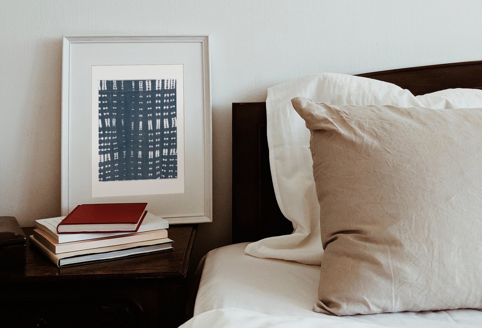 mud cloth fabric print framed next to a bed by Gert & Co